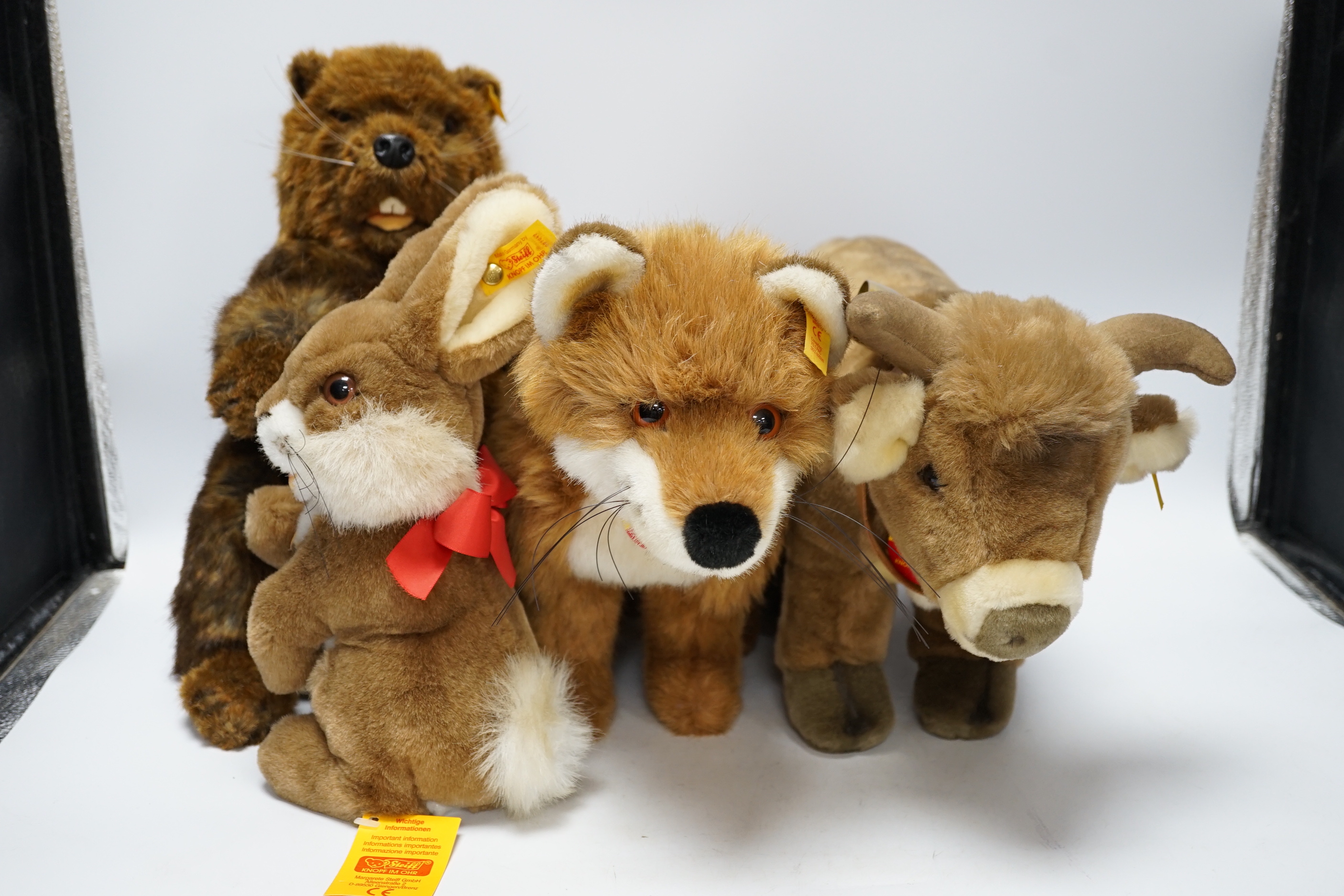 Thirteen Steiff yellow tag animals and one yellow tag bear, including Snorry fox, Mannie rabbit, Nagy beaver and Resi cow